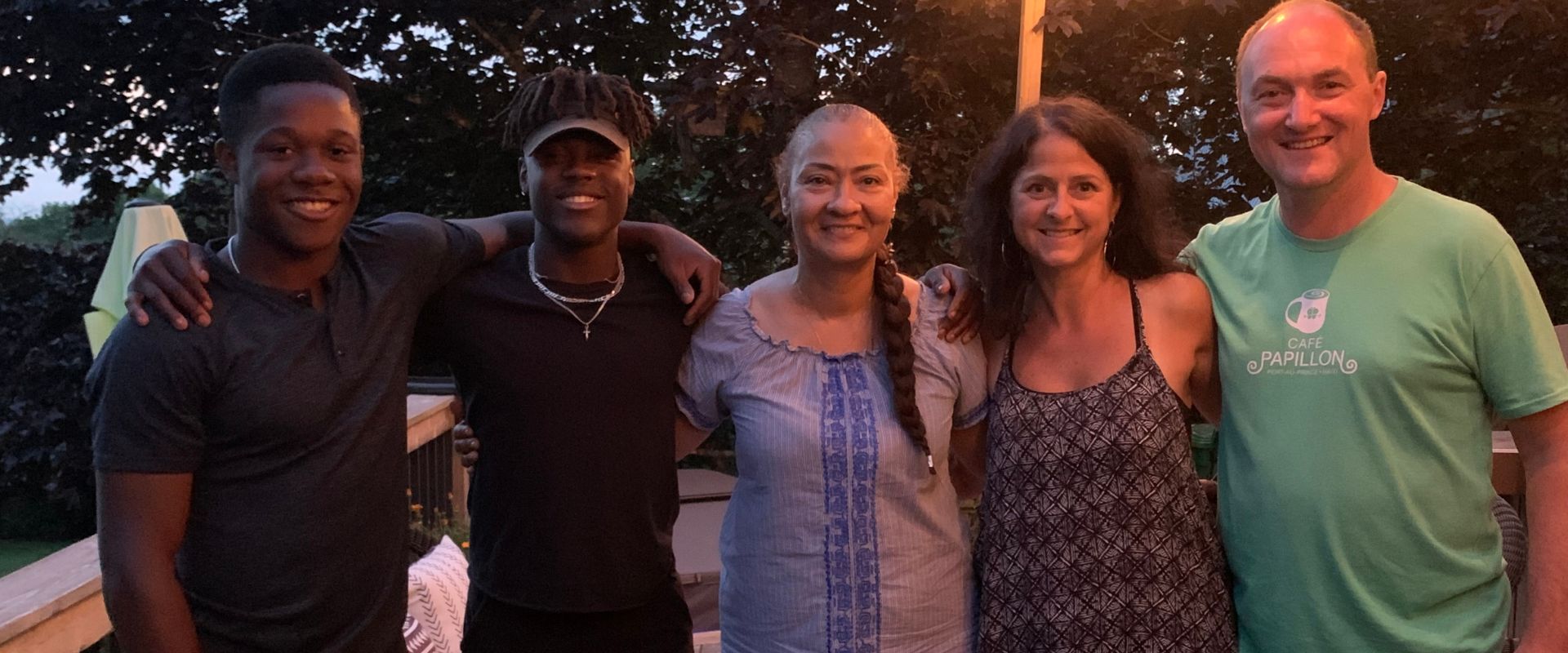 A family smiling together outdoors