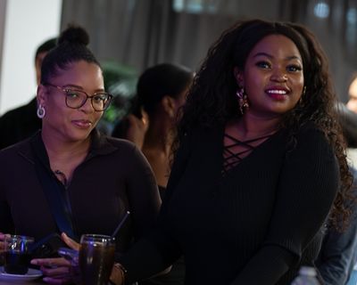 Two women smiling together at a Seeking Life event