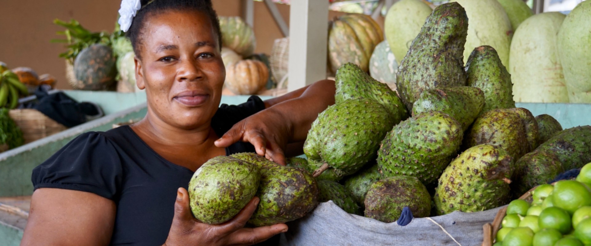 Woman selling produce at a market stall